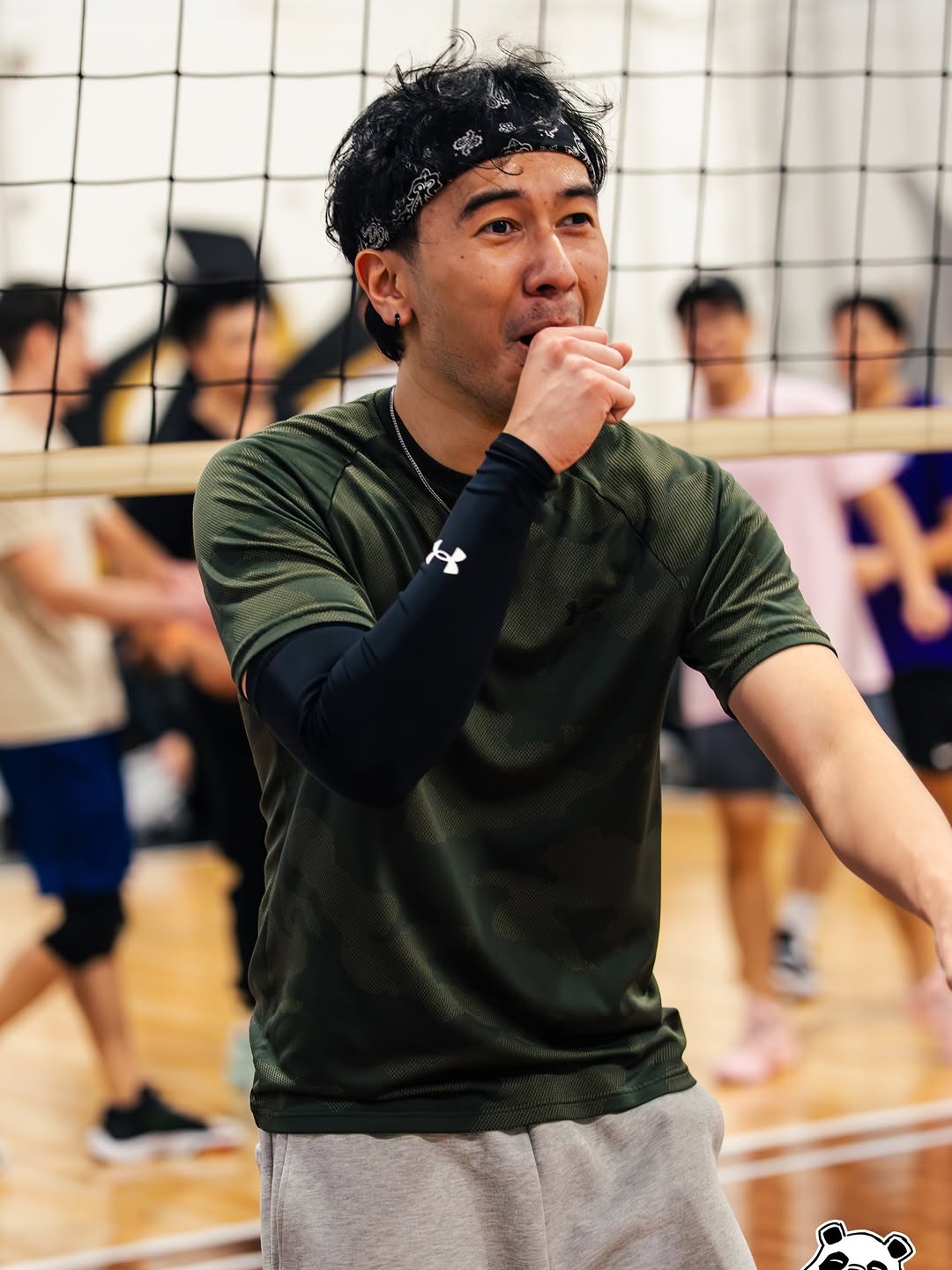 Volleyball player standing near the net during an indoor game